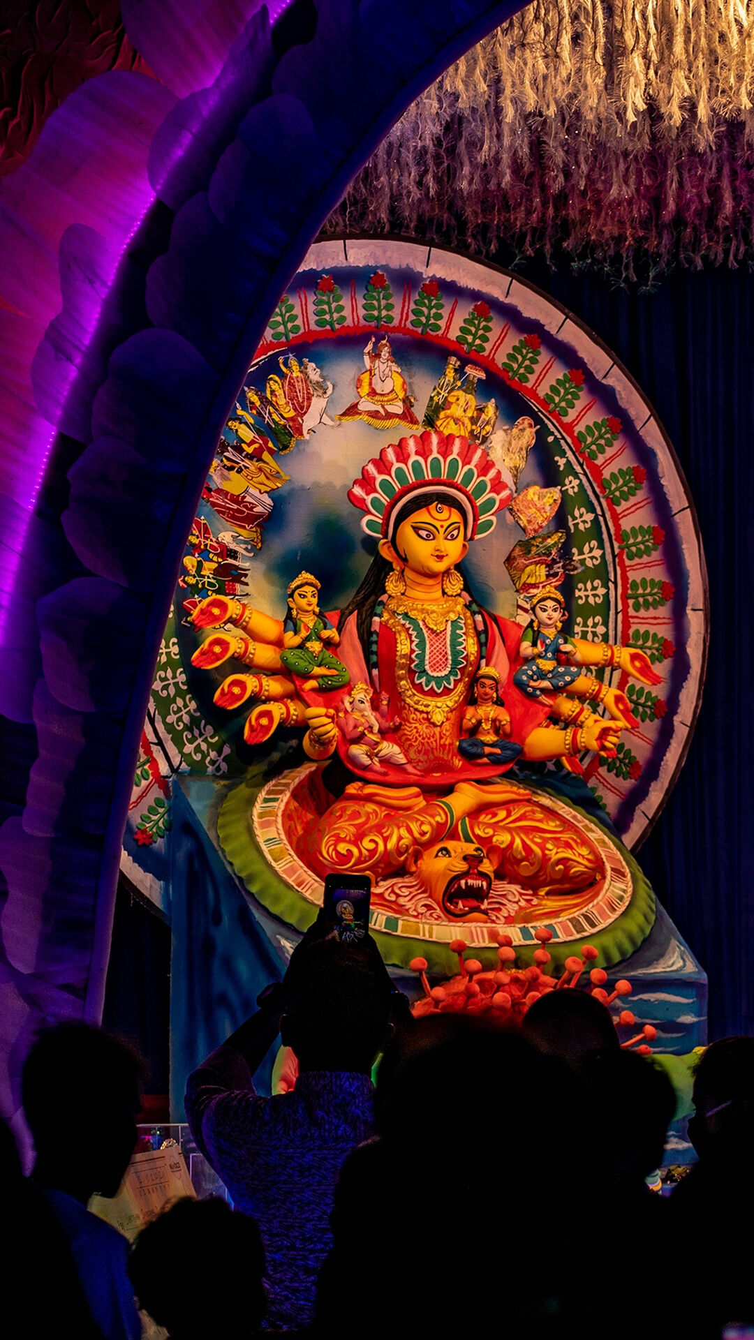 Devotees capturing a beautifully decorated Durga idol during Navratri festival celebration